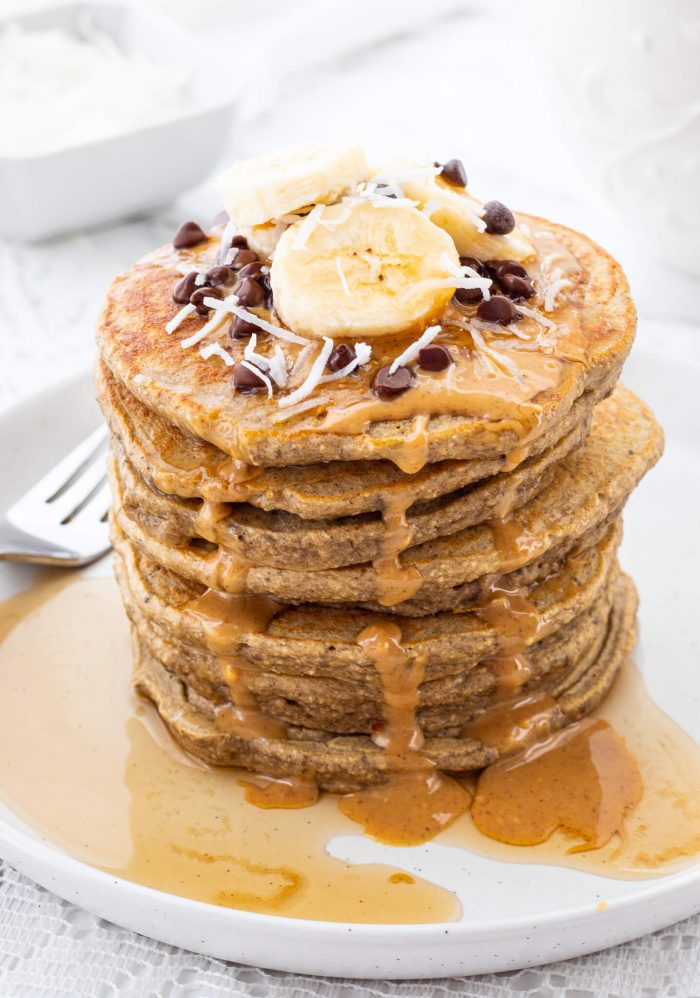 stack of protein pancakes with banana, peanut butter and chocolate chips