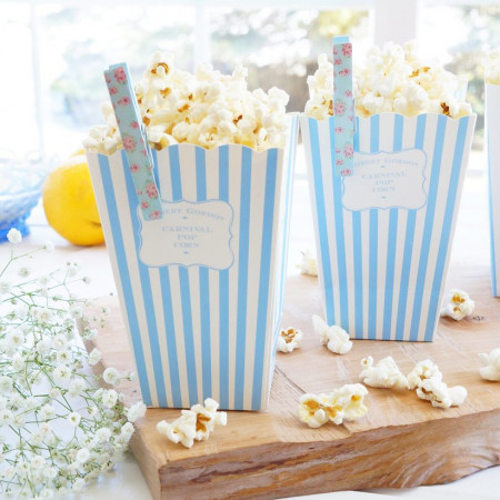 Two blue-and-white striped containers heaping with lemon parmesan popcorn