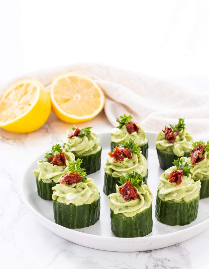 avocado goat cheese cucumber appetizer bites on a plate