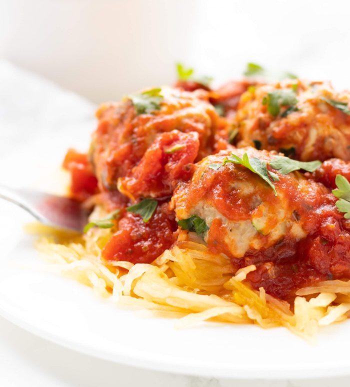 Closeup of Chicken Quinoa Meatballs on a bed of spaghetti squash
