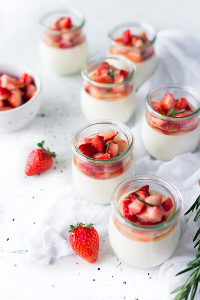 Jars of yogurt topped with strawberries