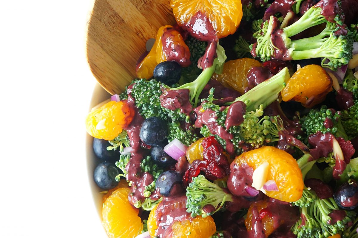 Wooden spatula in a bowl of Blueberry Mandarin Broccoli Salad