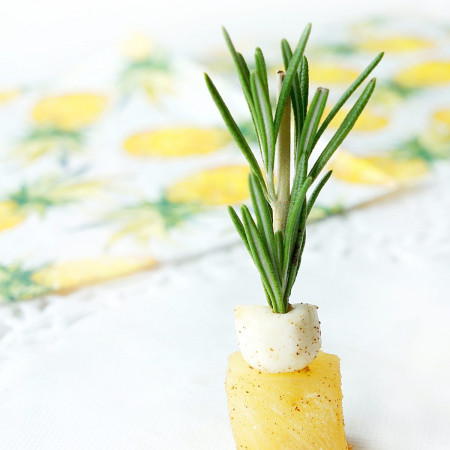 Closeup of a mini Roasted Pineapple with mozzarella and rosemary