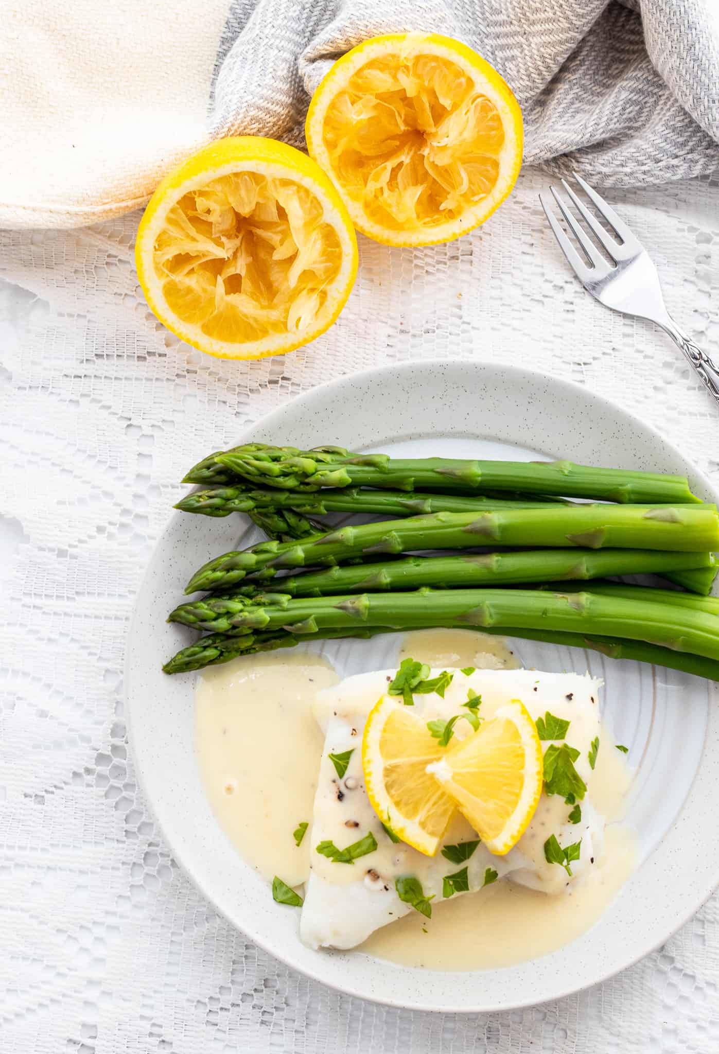 Finished fish recipe with lemon sauce and asparagus
