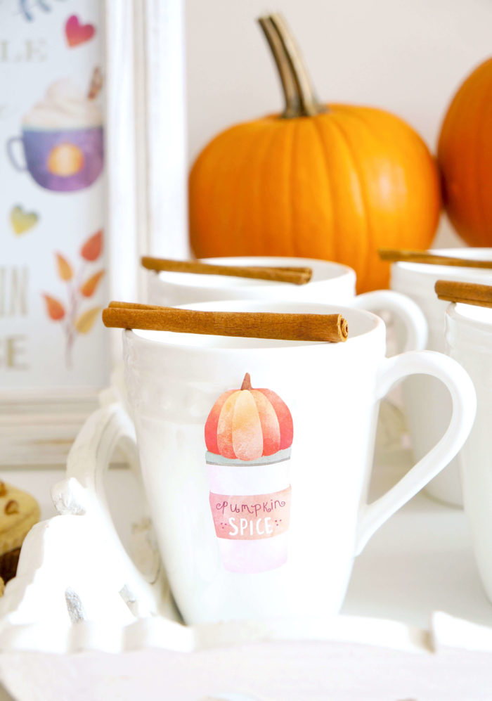 White mug labeled \"pumpkin spice\" with a cinnamon stick on top