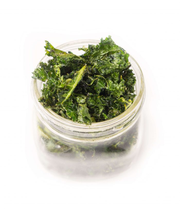 Mason jar overflowing with kale chips