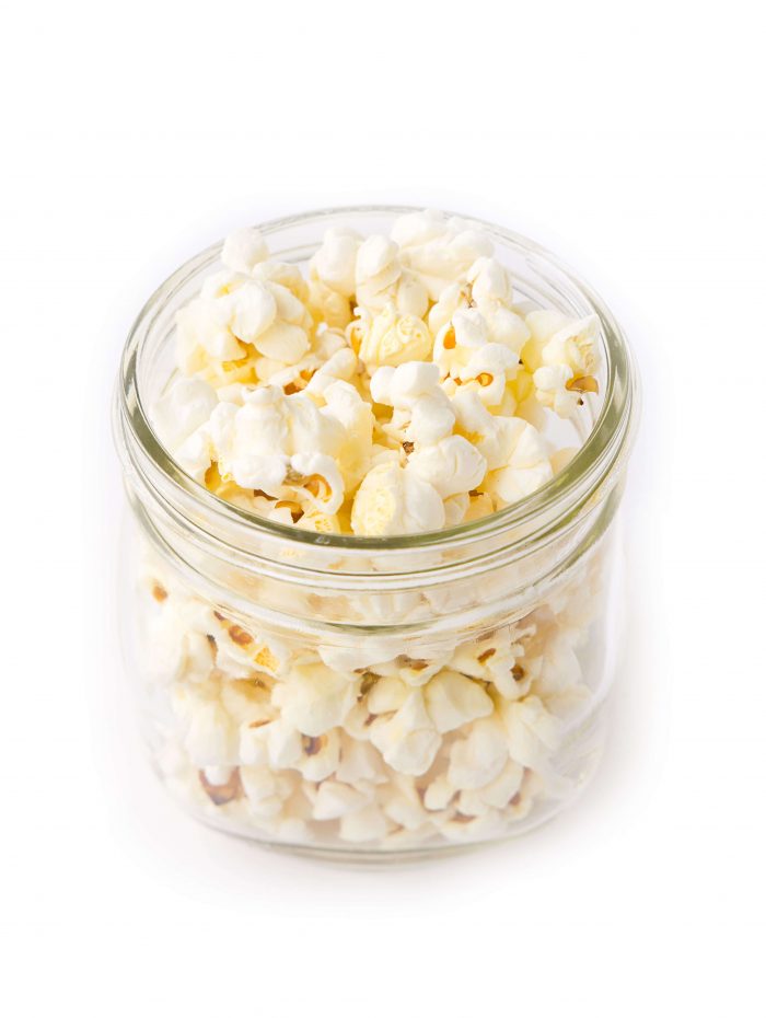 Small jar overflowing with popcorn