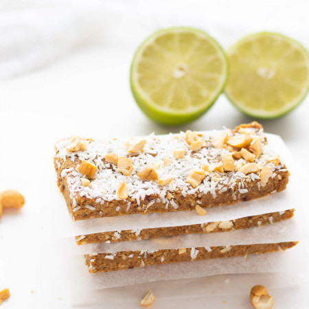 Stack of three No-Bake Key Lime Protein Bars separated by parchment paper