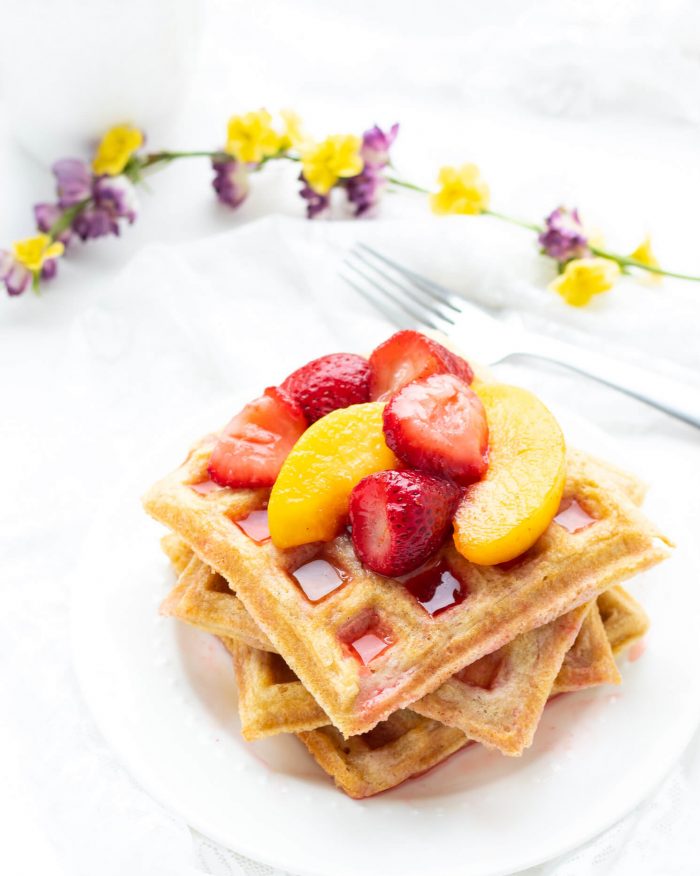 Stack of Paleo Waffles piled with fruit on a plate