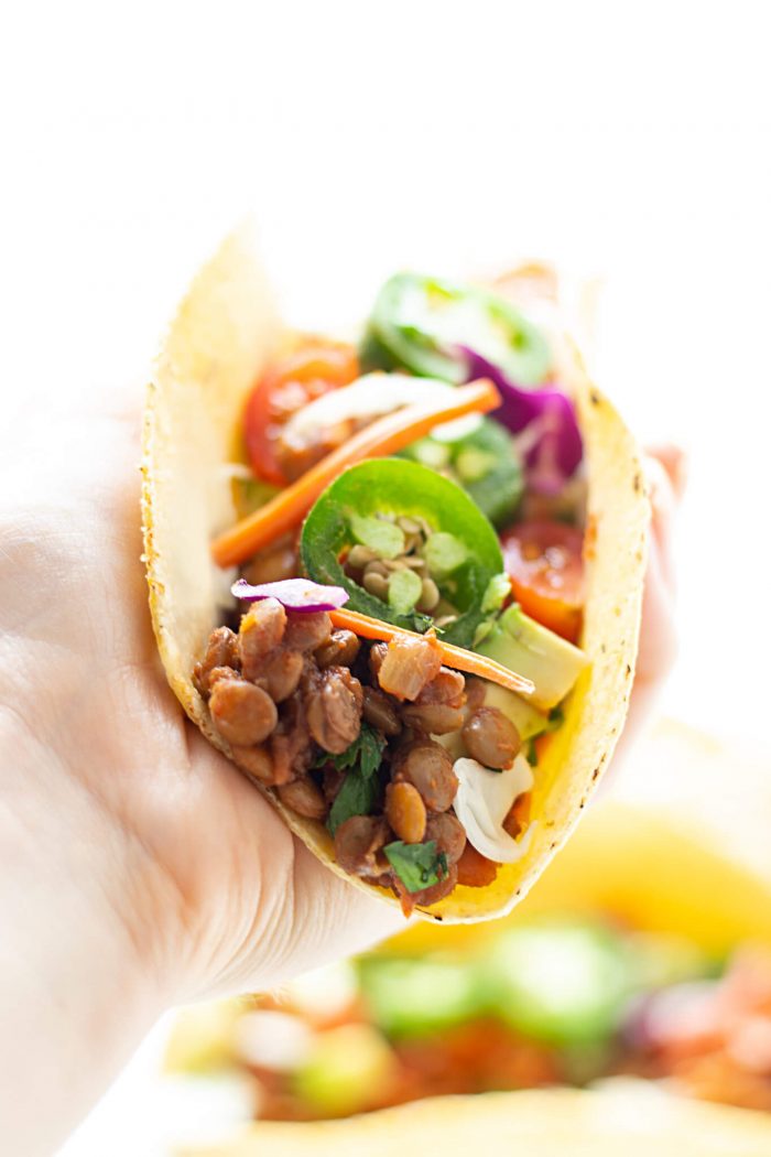 Hand holding an assembled Vegan Lentil Taco