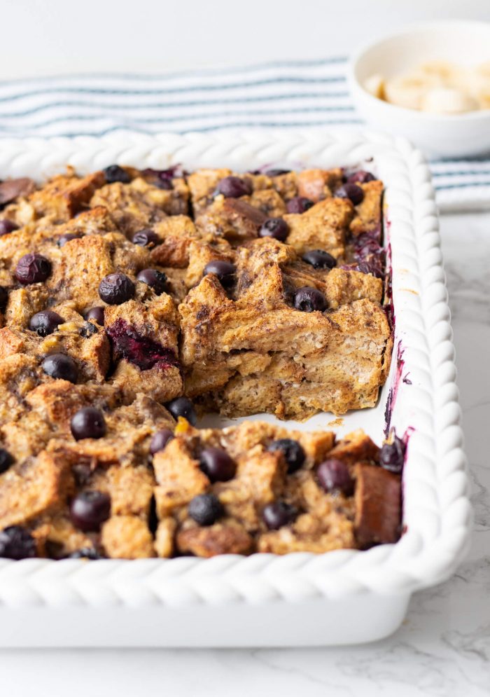 Blueberry Banana Baked French Toast Casserole in pan with piece cut out