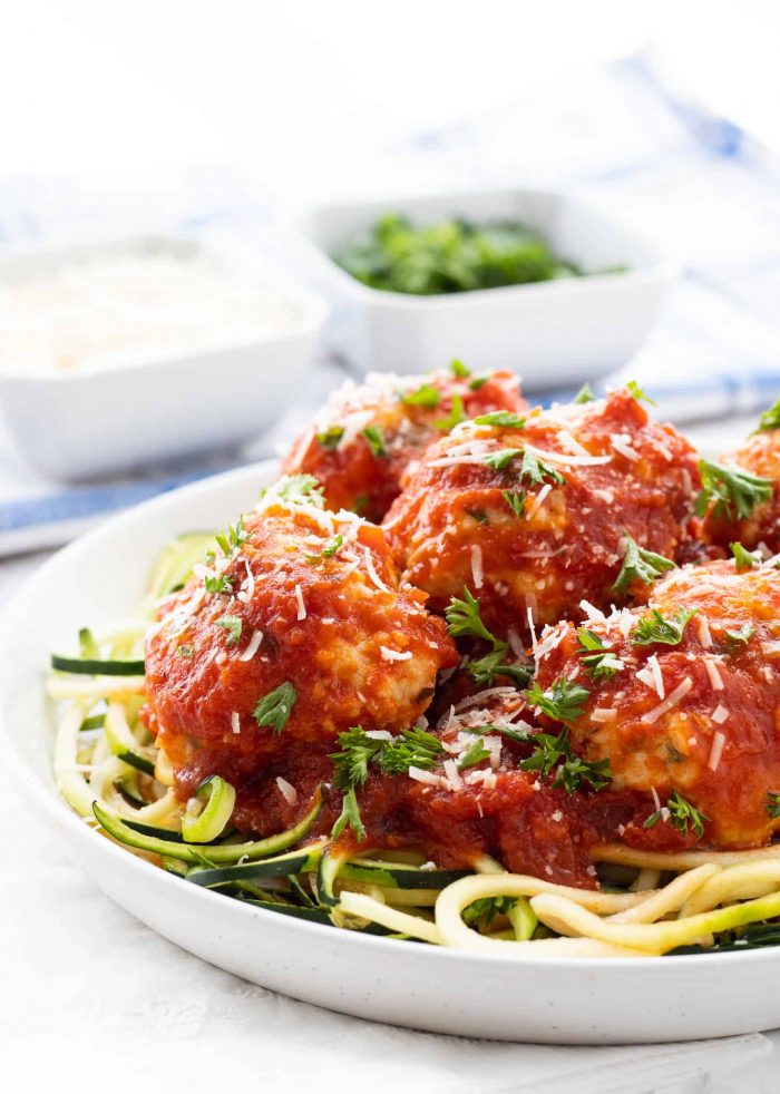 Plate of low-carb chicken meatballs over zucchini noodles