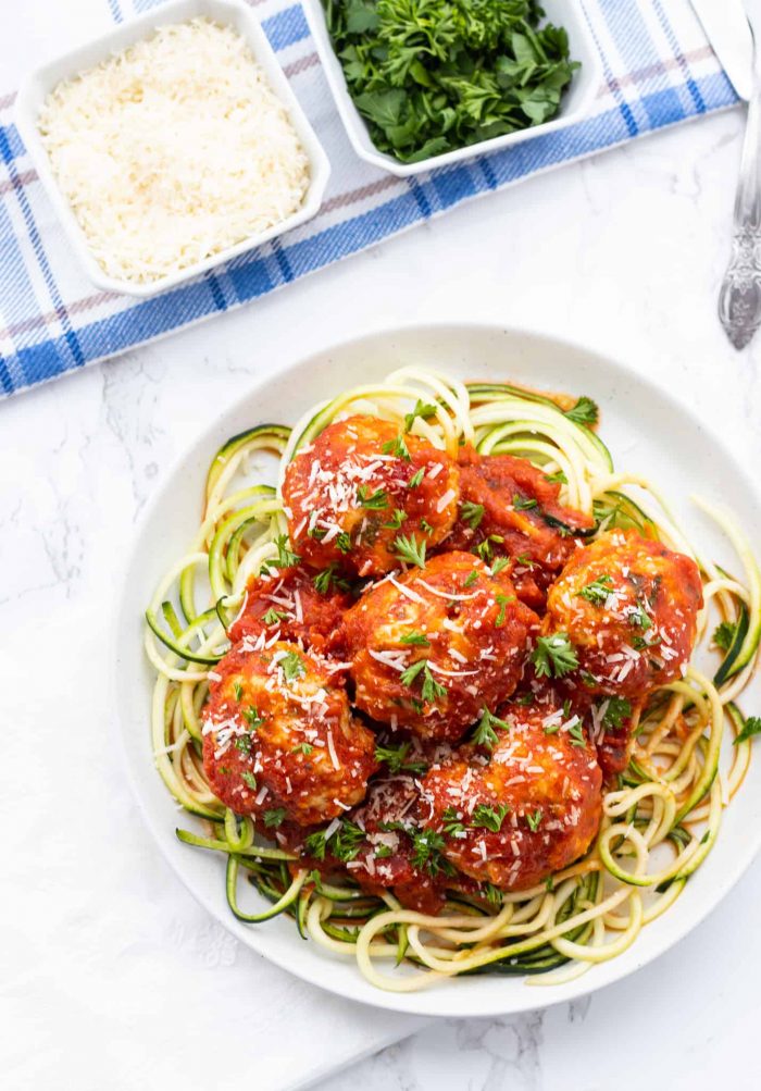 Overhead shot of low-carb chicken meatballs over zucchini noodles