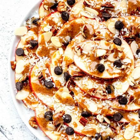 apple nachos on a white plate with toppings