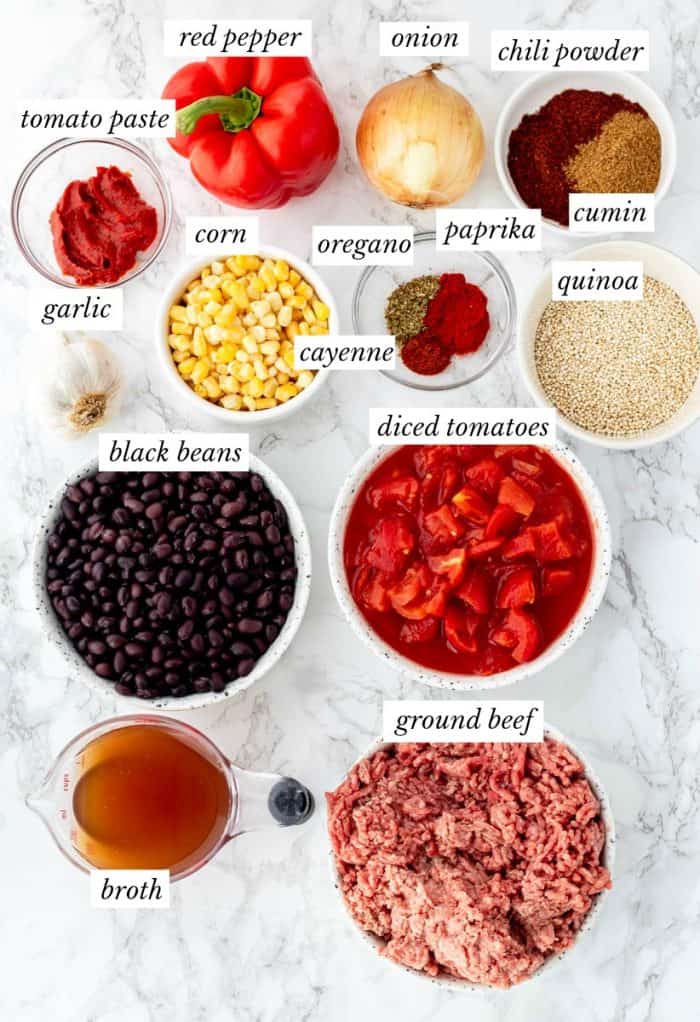 ingredients for chili on marble background with labels