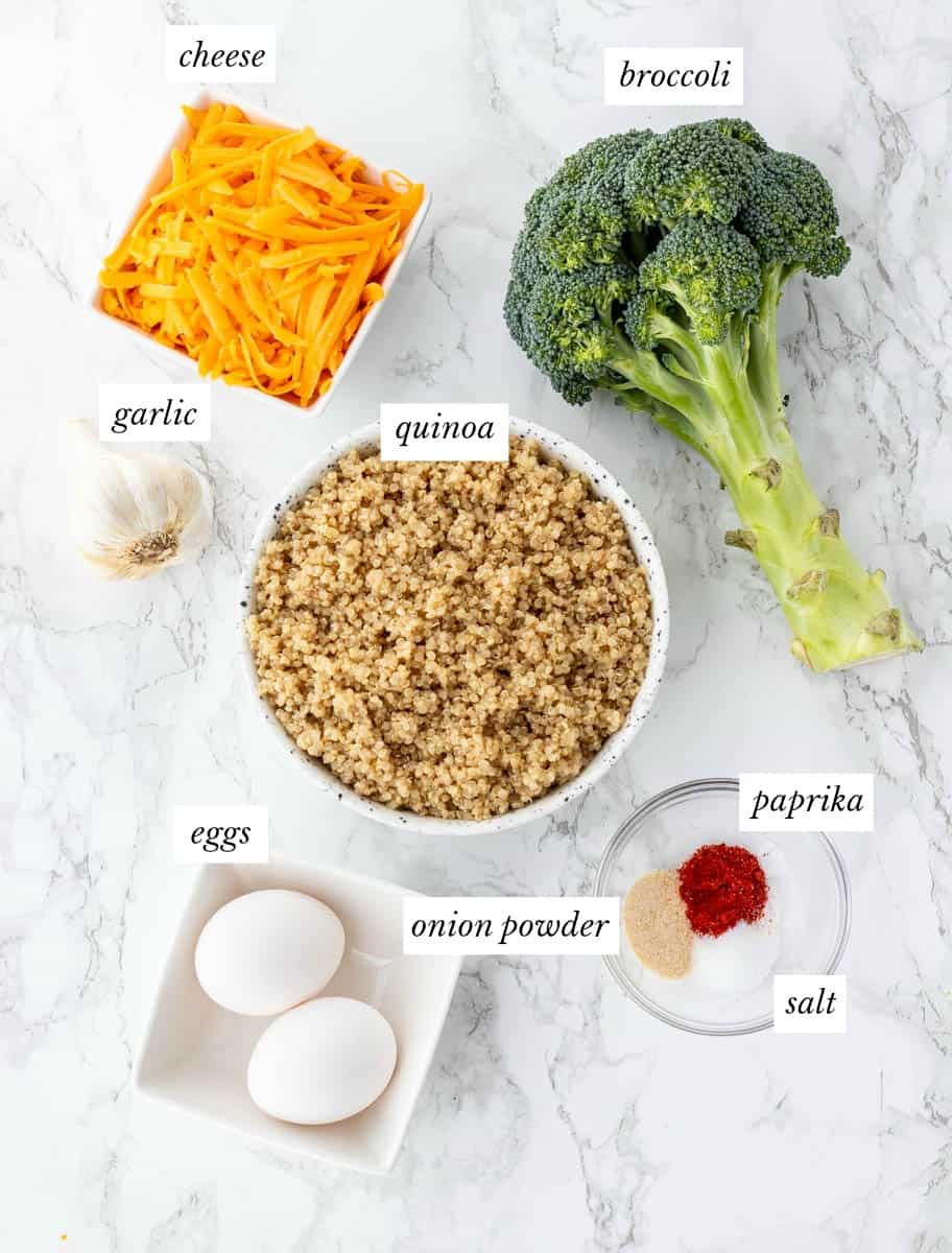 Ingredients required for quinoa bites with labels on a marble background.