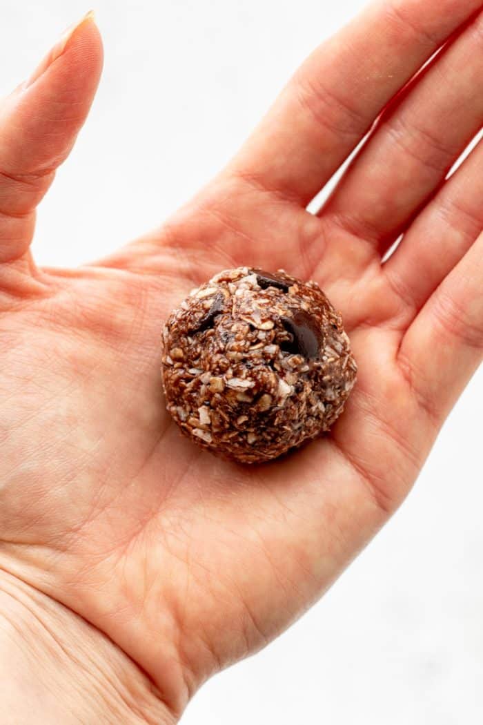 A rolled chocolate ball in a hand.