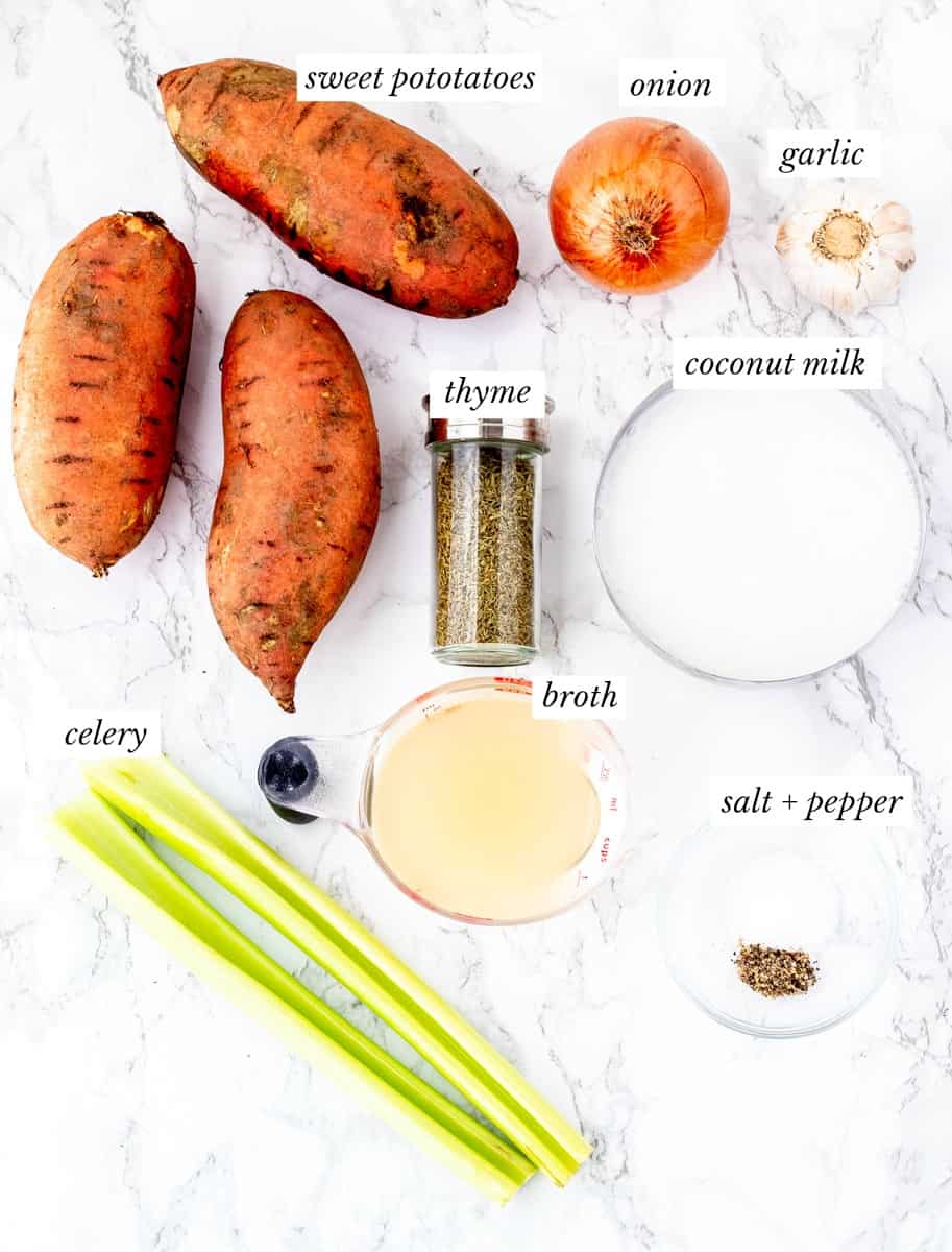Ingredients for sweet potato soup with labels on marble background