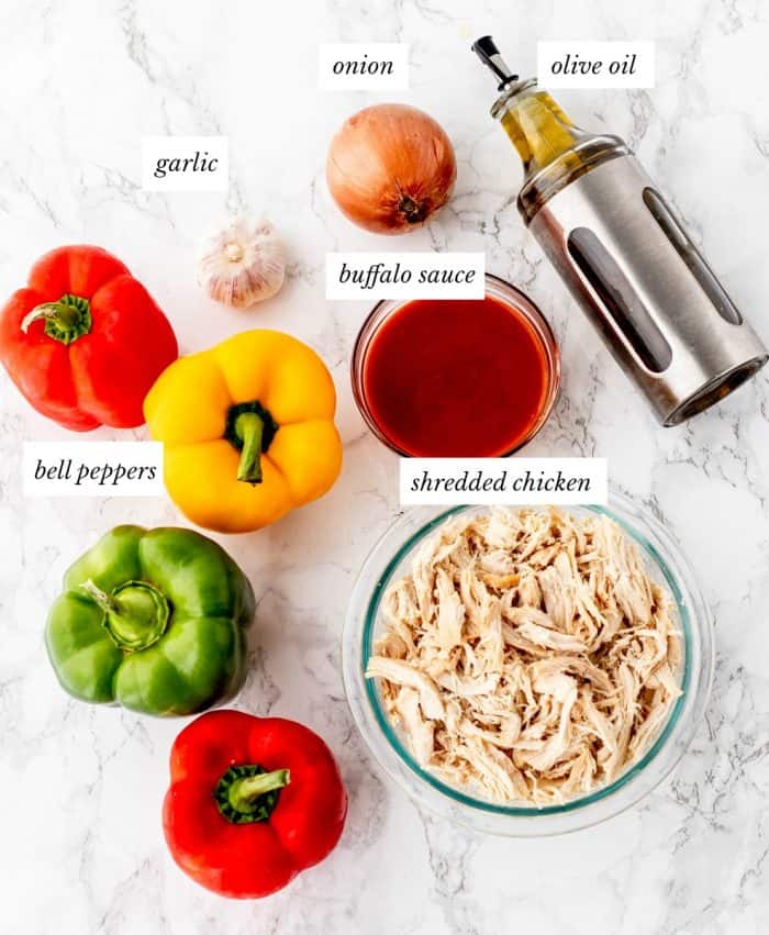 ingredients required for buffalo chicken stuffed peppers on marble background with labels