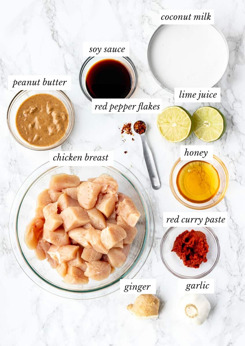 ingredients for Thai peanut chicken with labels on marble background