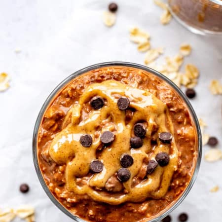 Chocolate overnight oats with peanut butter and chocolate chips on top