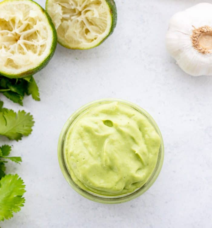 Avocado and lime dip in a glass jar.