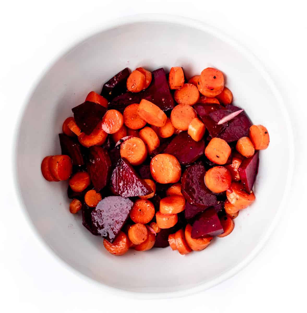 Carrots and beets in a white bowl.
