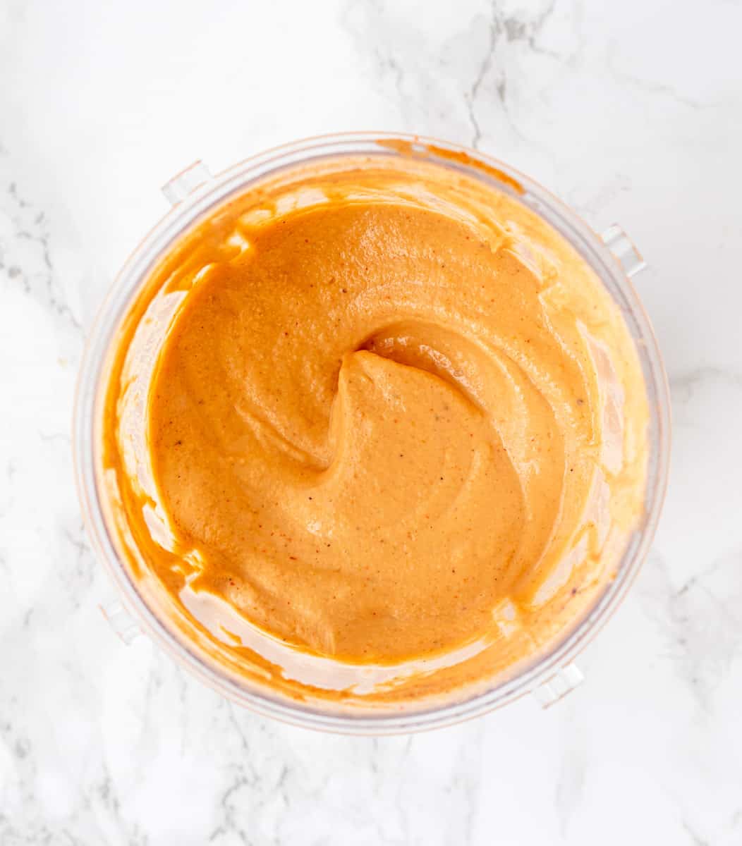 The special sauce in a blender on a marble background
