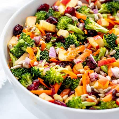 close up of broccoli cranberry salad in a large white bowl
