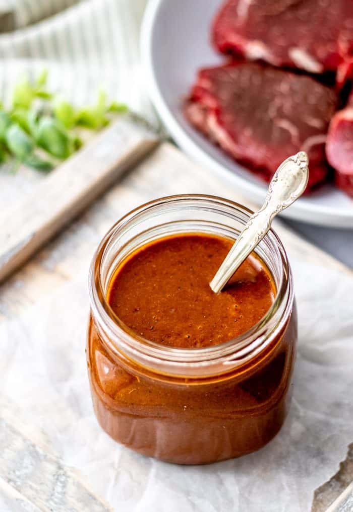 Easy steak marinade in a glass jar with a spoon.