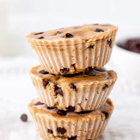 Three chocolate chip cookie dough bites stacked on top of each other.