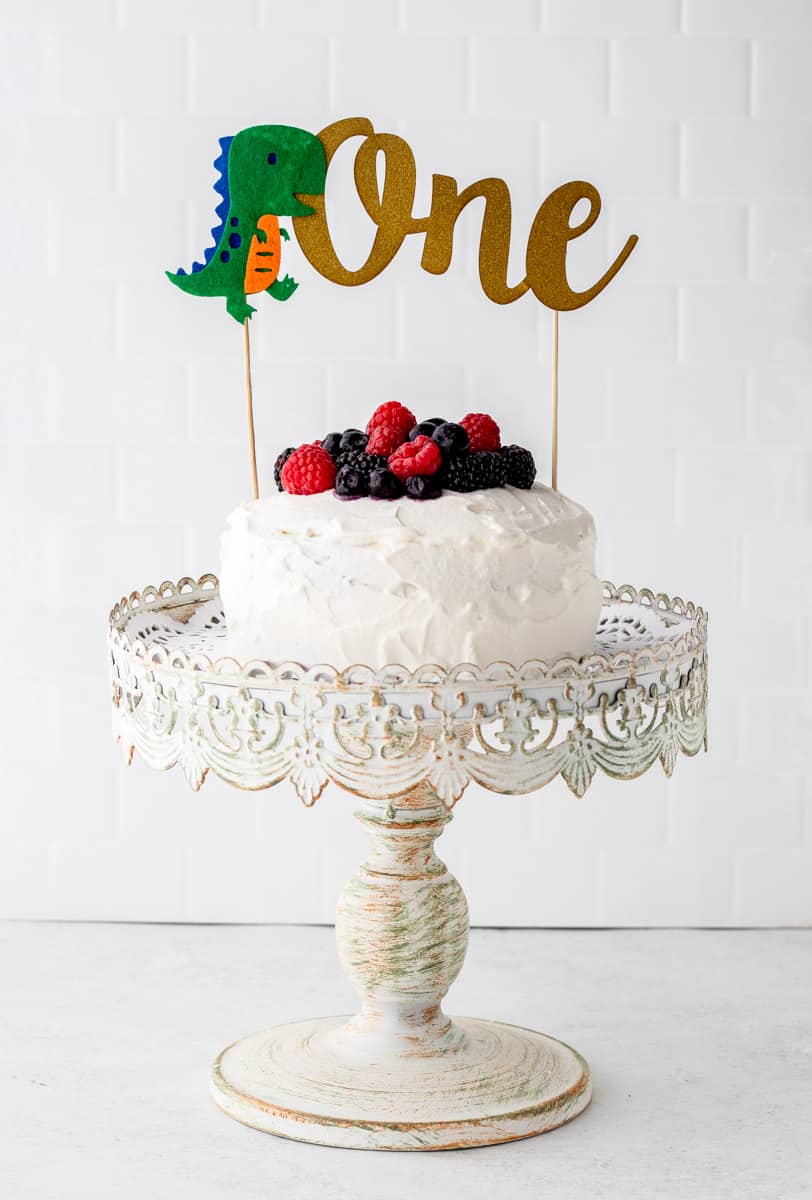 A smash cake with a 'one' banner on top of it.