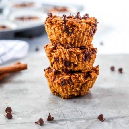 Three pumpkin oatmeal muffins stacked on top of each other.