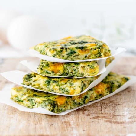 Veggie frittata cut into fingers and stacked on top of each other.