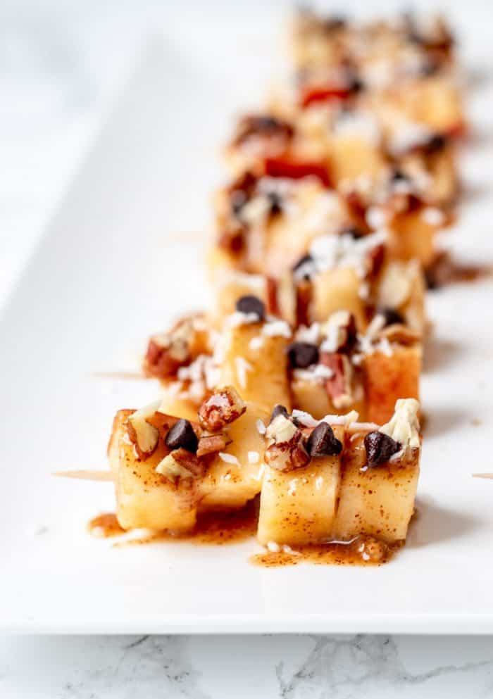 Close up of the toppings on the apple skewers.