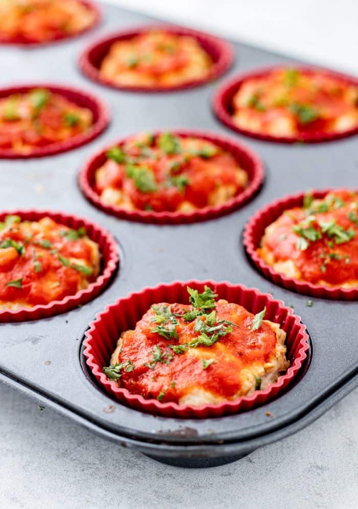 close up of baked mini meatloaf muffin in a muffin tin