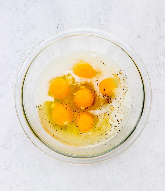 Eggs, milk and seasonings in a bowl.