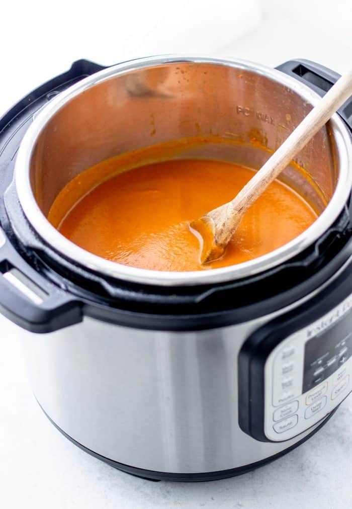 A spoon in the pumpkin soup in the Instant Pot.
