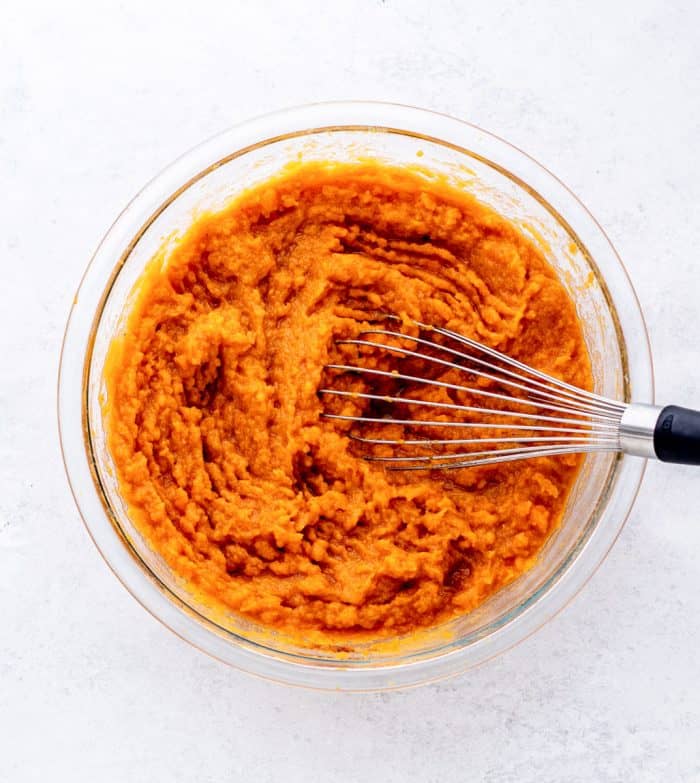 The sweet potato whisked with the other ingredients in a bowl.