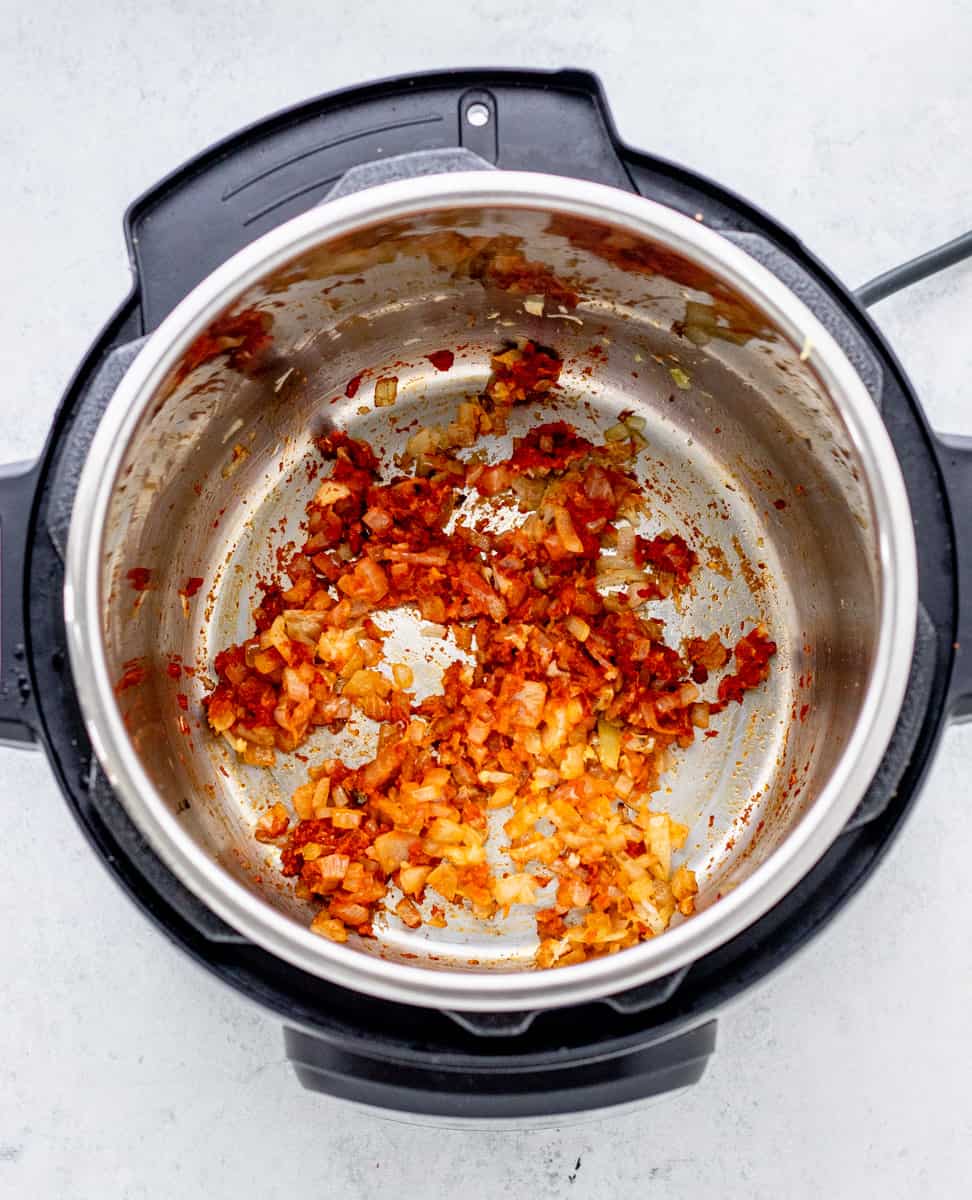 Onions, garlic and curry paste in the instant pot