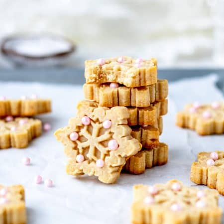 Five almond flour shortbread cookies stacked on top of each other.