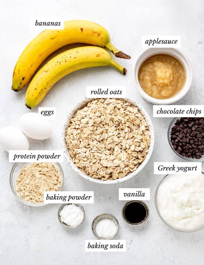 ingredients for the protein muffins on a grey background with labels