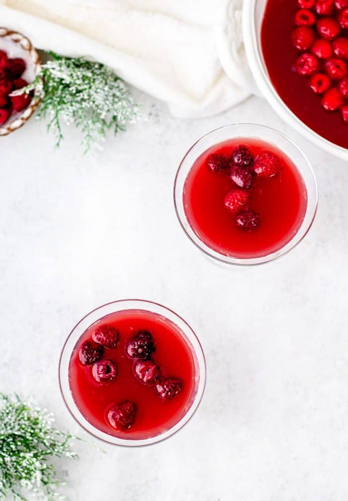 overhead shot of punch in glasses with raspberries