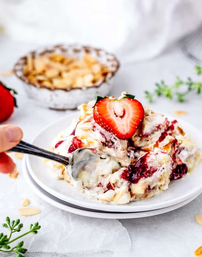 a spoon digging into the trifle on a plate