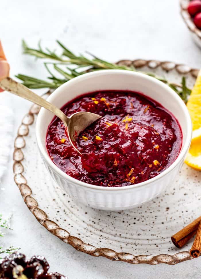 A spoon in a bowl of cranberry sauce.