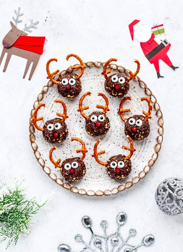 cute reindeer bites on a circular plate next to Christmas decorations