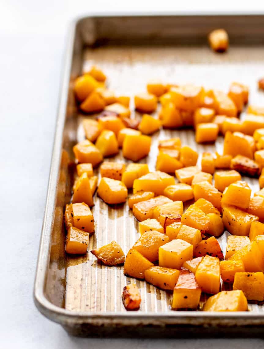 diced baked squash on a baking sheet