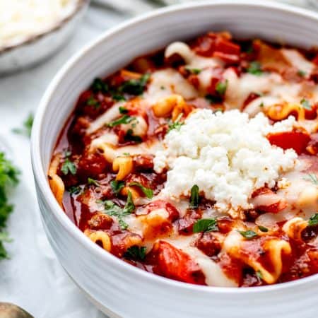 Lazy lasagna soup topped with ricotta and parmesan.