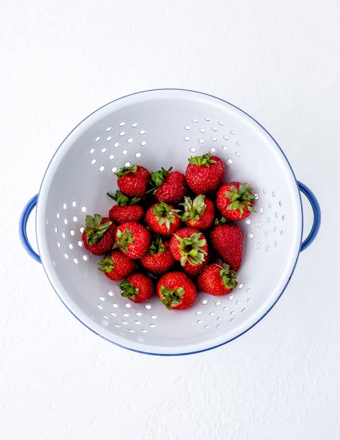 Fresh strawberries in a colander.