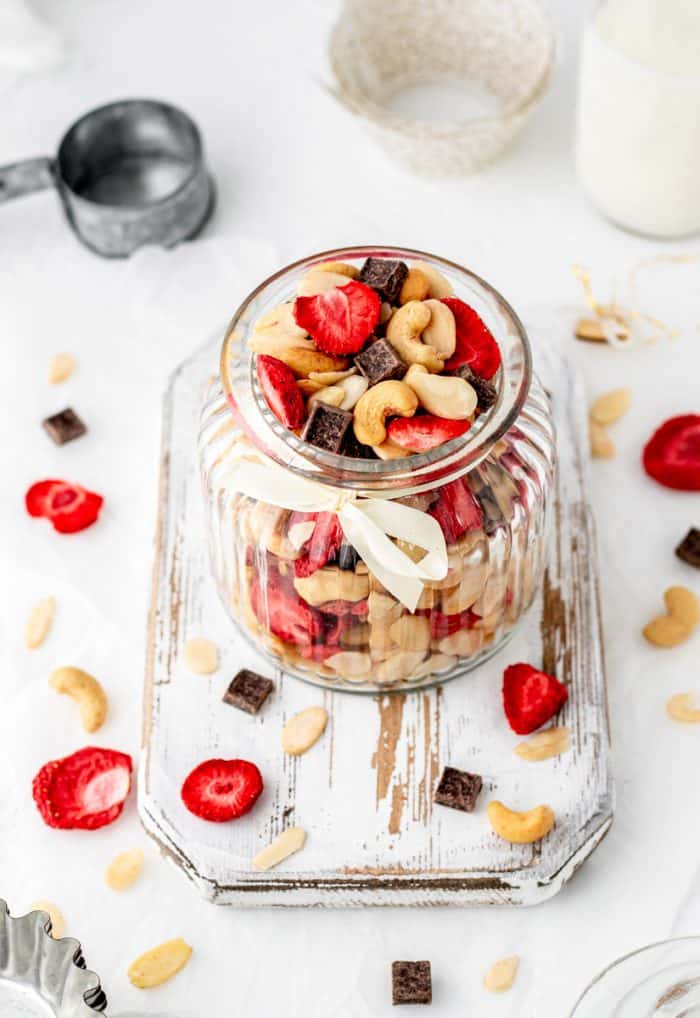Strawberry and nut trail mix in a glass jar.
